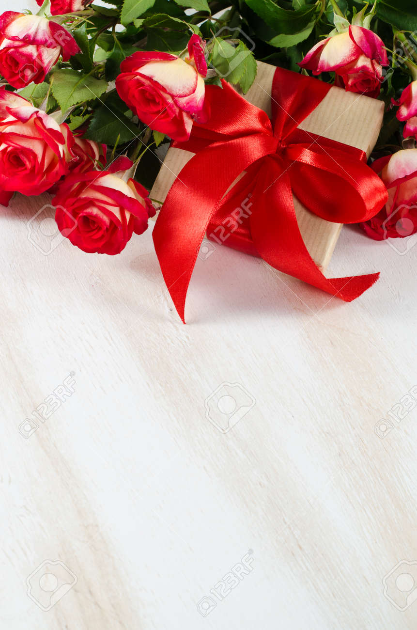 Red Roses Bouquet And Present On White Wooden Table Birthday