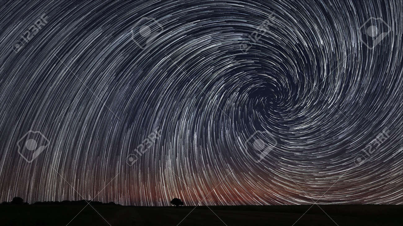Beautiful Star Trails over filed with lonely tree. Beautiful night sky. - 44222287 Beautiful Star Trails over filed with lonely tree. Beautiful night sky. - 44222287
