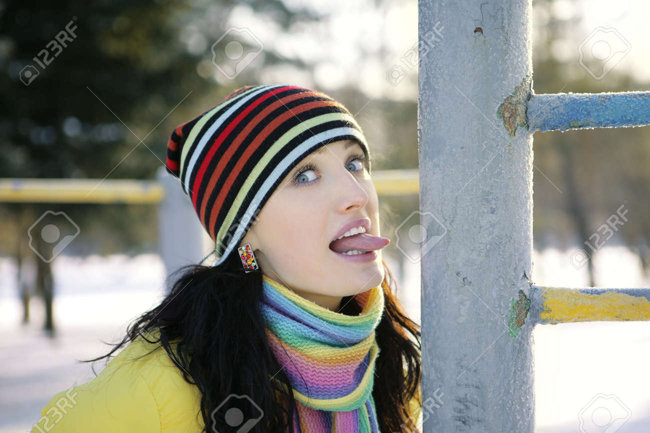 girl in winter in the park language iron pipe stock photo picture