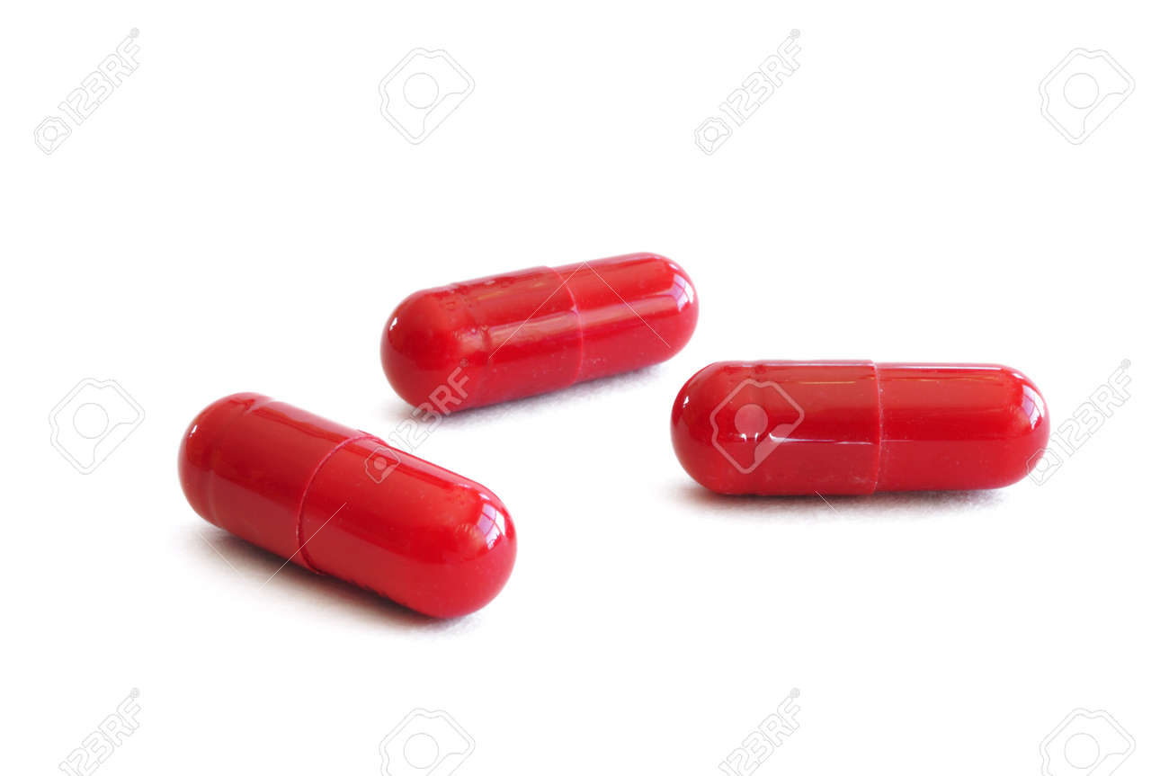 three red pills capsules isolated on a white background stock