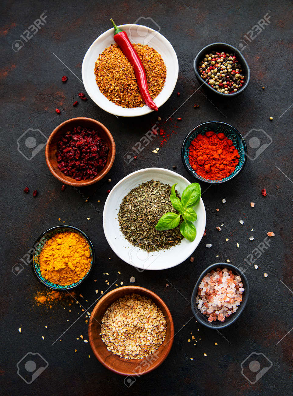 Various spices in a bowls on black concrete background. Top view copy space. - 155986733 Various spices in a bowls on black concrete background. Top view copy space. - 155986733