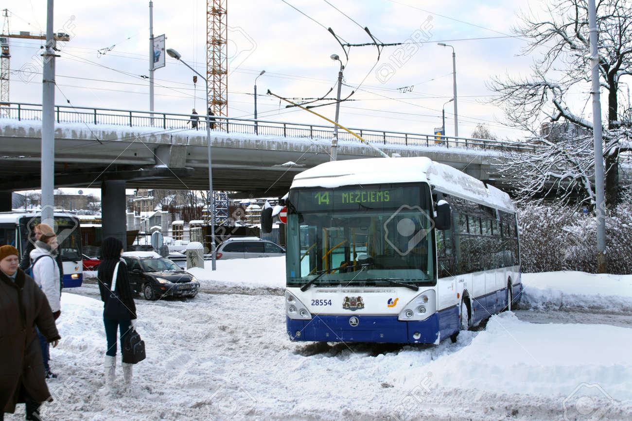 Dangerous traffic accident with public transport in Riga, Latvia on February 2, 2010. Trolleybus stuck in snow and blocked driving on slippery road. Massive snow in everywhere due to unbelievable winter storm in Europe. Luckly nobody is hurt. - 9386876 Dangerous traffic accident with public transport in Riga, Latvia on February 2, 2010. Trolleybus stuck in snow and blocked driving on slippery road. Massive snow in everywhere due to unbelievable winter storm in Europe. Luckly nobody is hurt. - 9386876