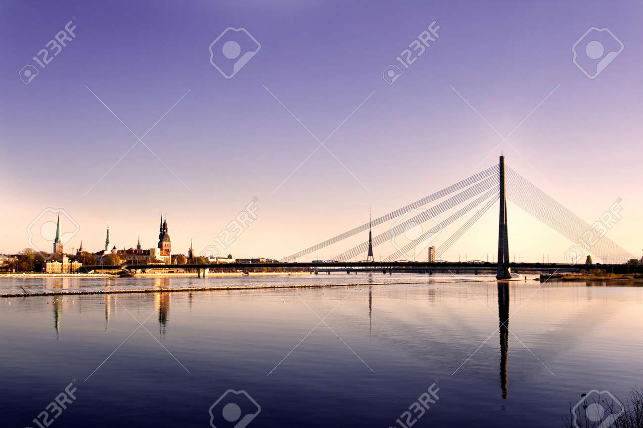 Classic view of Old Riga in Latvia. Cable-stayed bridge over the river of Daugava and Riga castle with Riga Cathedral in a front. TV tower, railway bridge and Saint Peter's church in a background. - 9413573 Classic view of Old Riga in Latvia. Cable-stayed bridge over the river of Daugava and Riga castle with Riga Cathedral in a front. TV tower, railway bridge and Saint Peter's church in a background. - 9413573