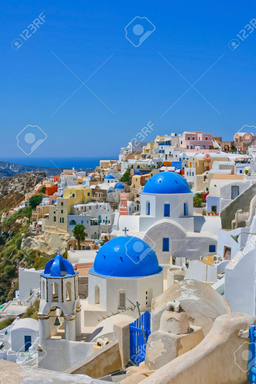 Magic view of Oia on island of Santorini in Greece. Traditional architecture with famous blue churches. - 9739464 Magic view of Oia on island of Santorini in Greece. Traditional architecture with famous blue churches. - 9739464