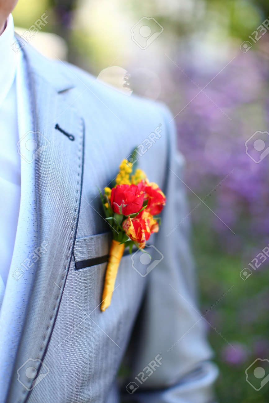 Wonderful wedding boutonniere on a costume of groom from beautiful colorful flowers. Nice bokeh in the background. - 12904775 Wonderful wedding boutonniere on a costume of groom from beautiful colorful flowers. Nice bokeh in the background. - 12904775