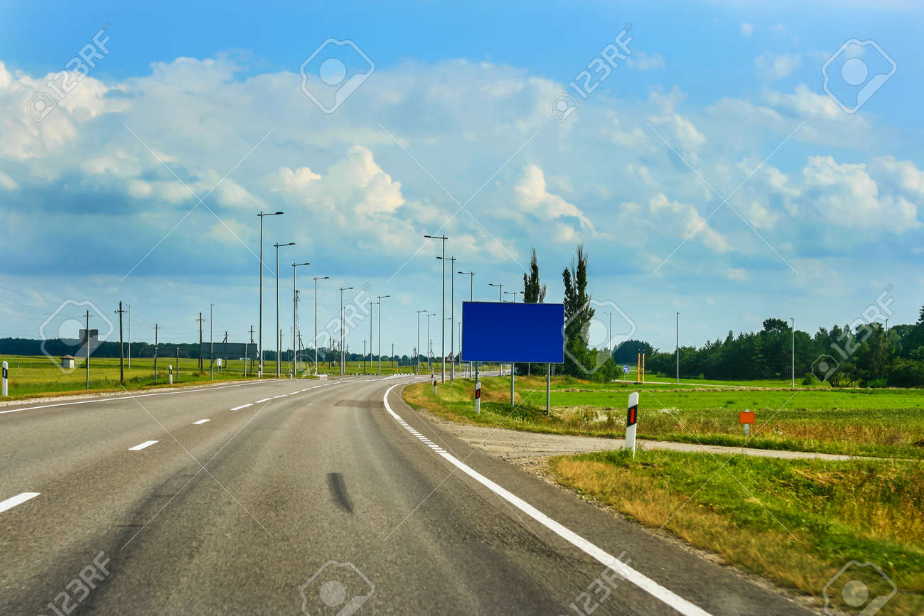 European route E67 it s part of Via Baltica road in countryside of Lithuania with beautiful clouds and fields - 19740674 European route E67 it s part of Via Baltica road in countryside of Lithuania with beautiful clouds and fields - 19740674