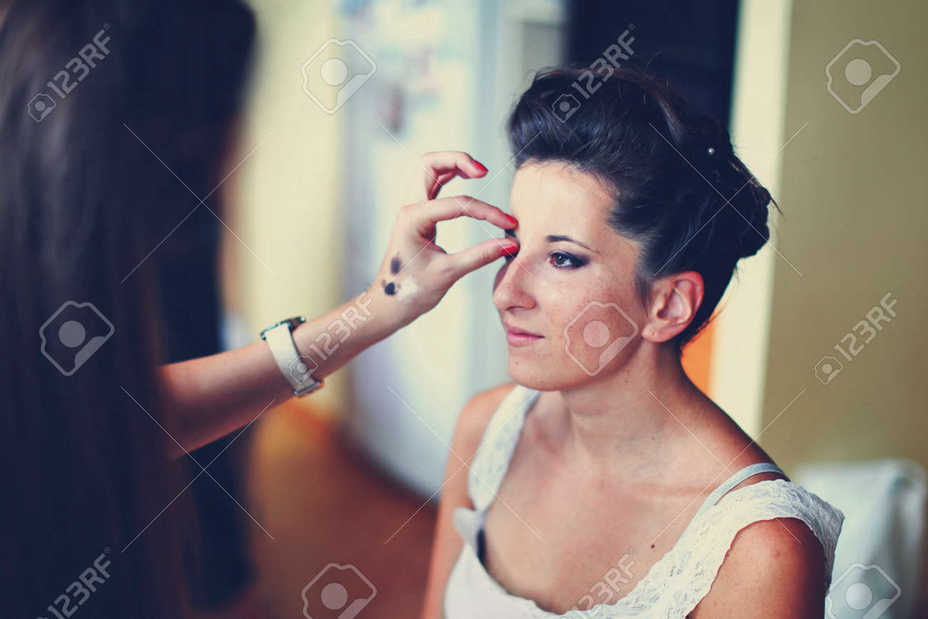 Bride's morning. Process of makeup artist preparing the bride before wedding. - 131703372 Bride's morning. Process of makeup artist preparing the bride before wedding. - 131703372