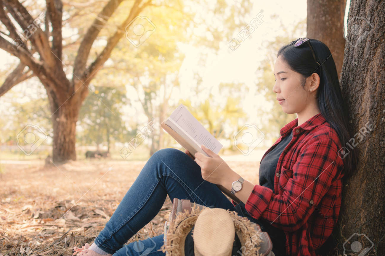 enjoying moment hipster woman reading a book and sitting under