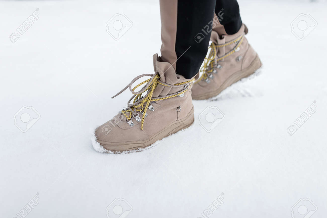 Winter leather stylish woman\u0027s boots with yellow laces. Female..