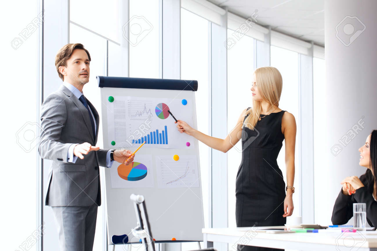 workers at business meeting looking at presentation of financial business meeting presentation