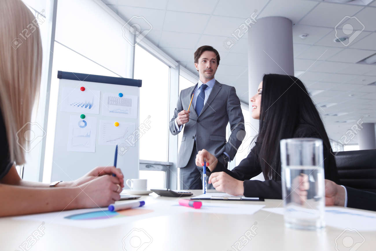 workers at business meeting looking at presentation of financial business meeting presentation