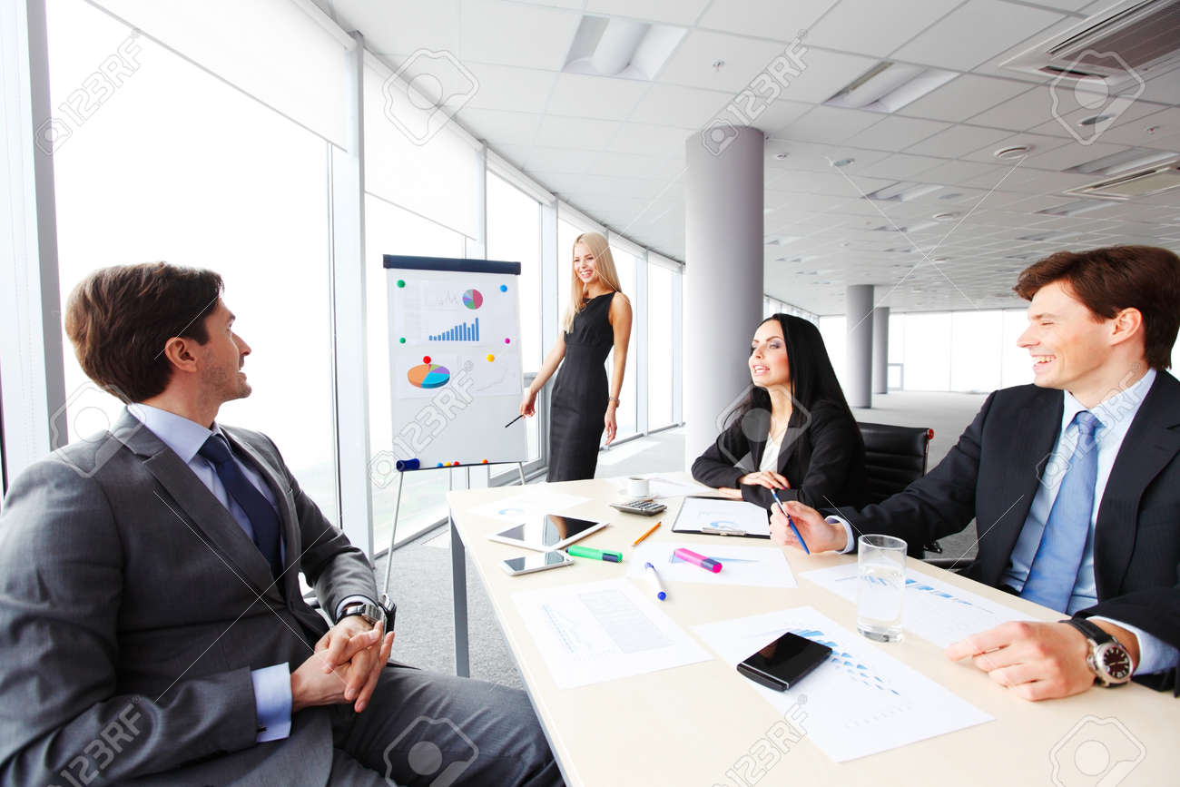 workers at business meeting looking at presentation of financial business meeting presentation