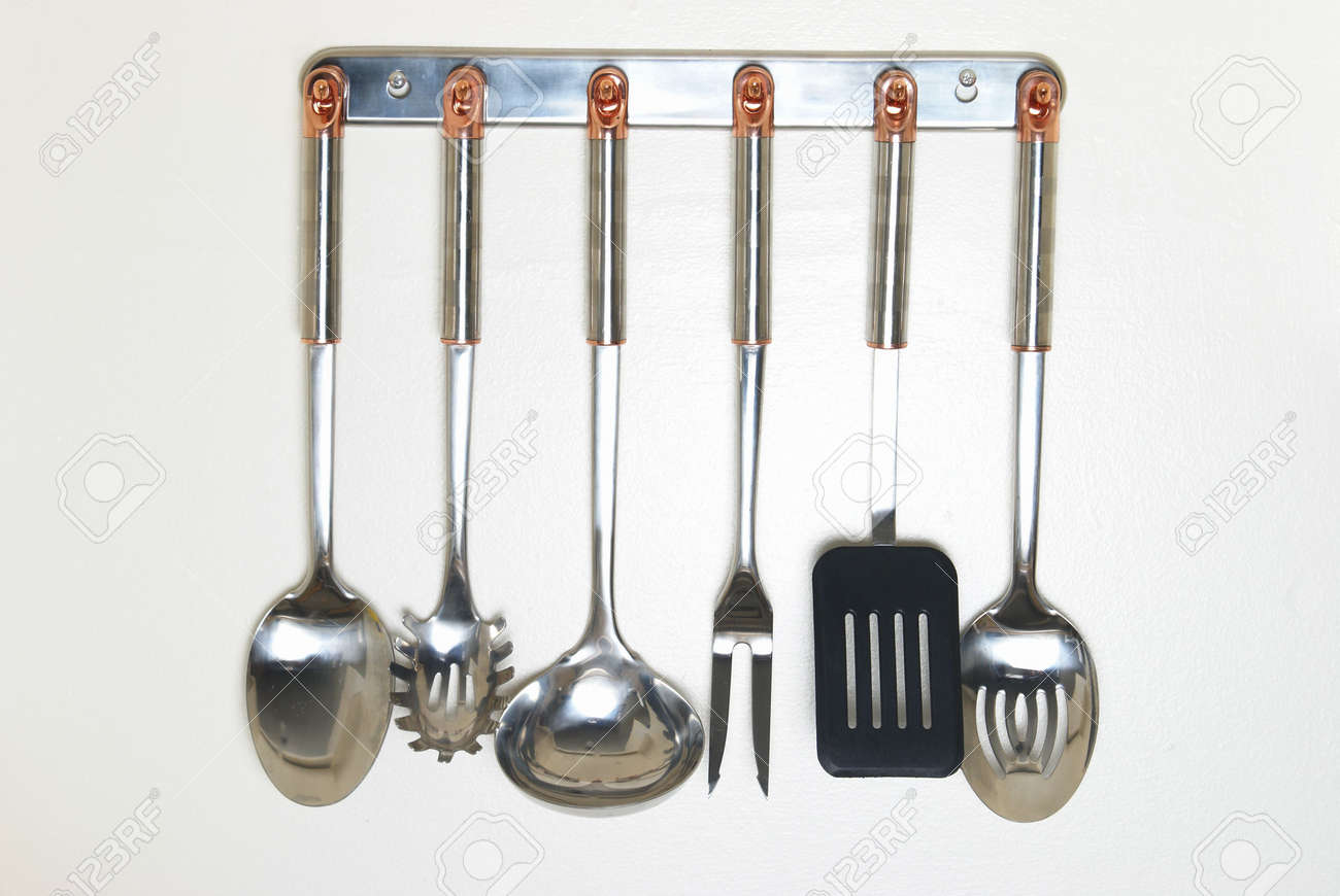 A Rack Of Kitchen Utensils Hanging On The Wall Stock Photo - A Rack Of Kitchen Utensils Hanging On The Wall Stock Photo a rack of kitchen utensils hanging on the wall stock photo - a rack of kitchen utensils hanging on the wall stock photo
