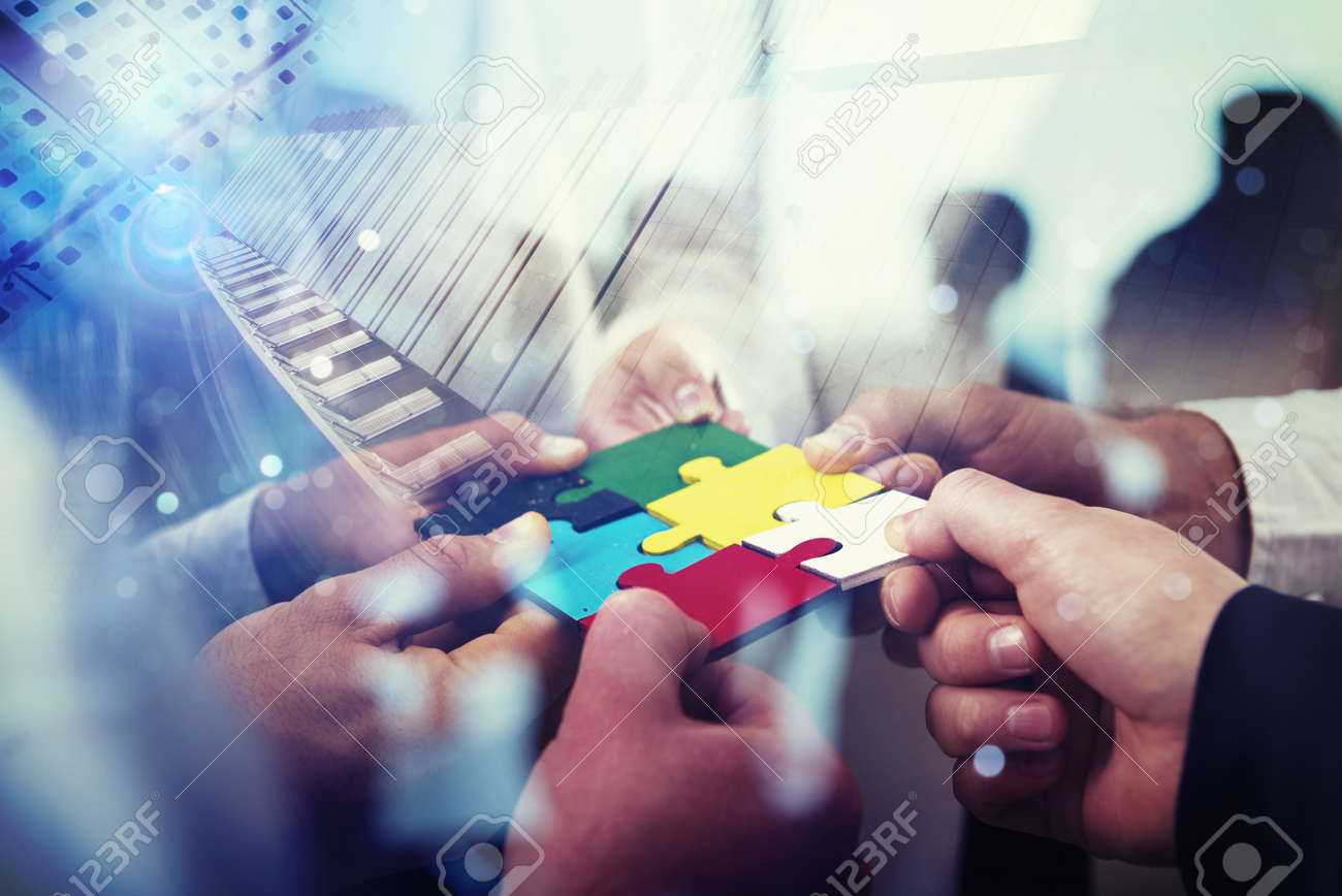 Business people join puzzle pieces in office. Concept of teamwork and partnership. double exposure with light effects - 109826206 Business people join puzzle pieces in office. Concept of teamwork and partnership. double exposure with light effects - 109826206