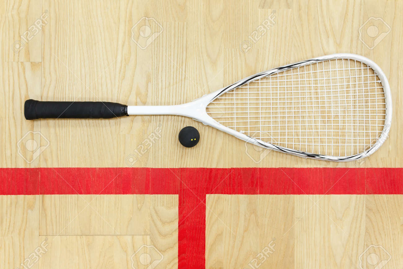 white squash racket and ball on the wooden floor top view. Racquetball equipment on the court near red line - 76549541 white squash racket and ball on the wooden floor top view. Racquetball equipment on the court near red line - 76549541