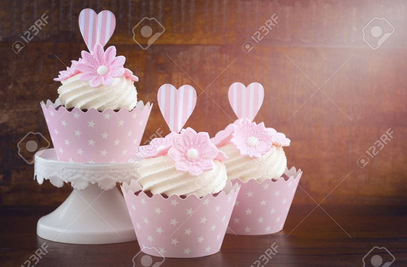 Wedding Day Shabby Chic Style Pink Cupcakes On Dark Recycled Vintage Wood  Background, With Applied Retro Style Filters And Added Lens Flare Light  Stream. Stock Photo, Picture and Royalty Free Image. Image, image size:1300x855