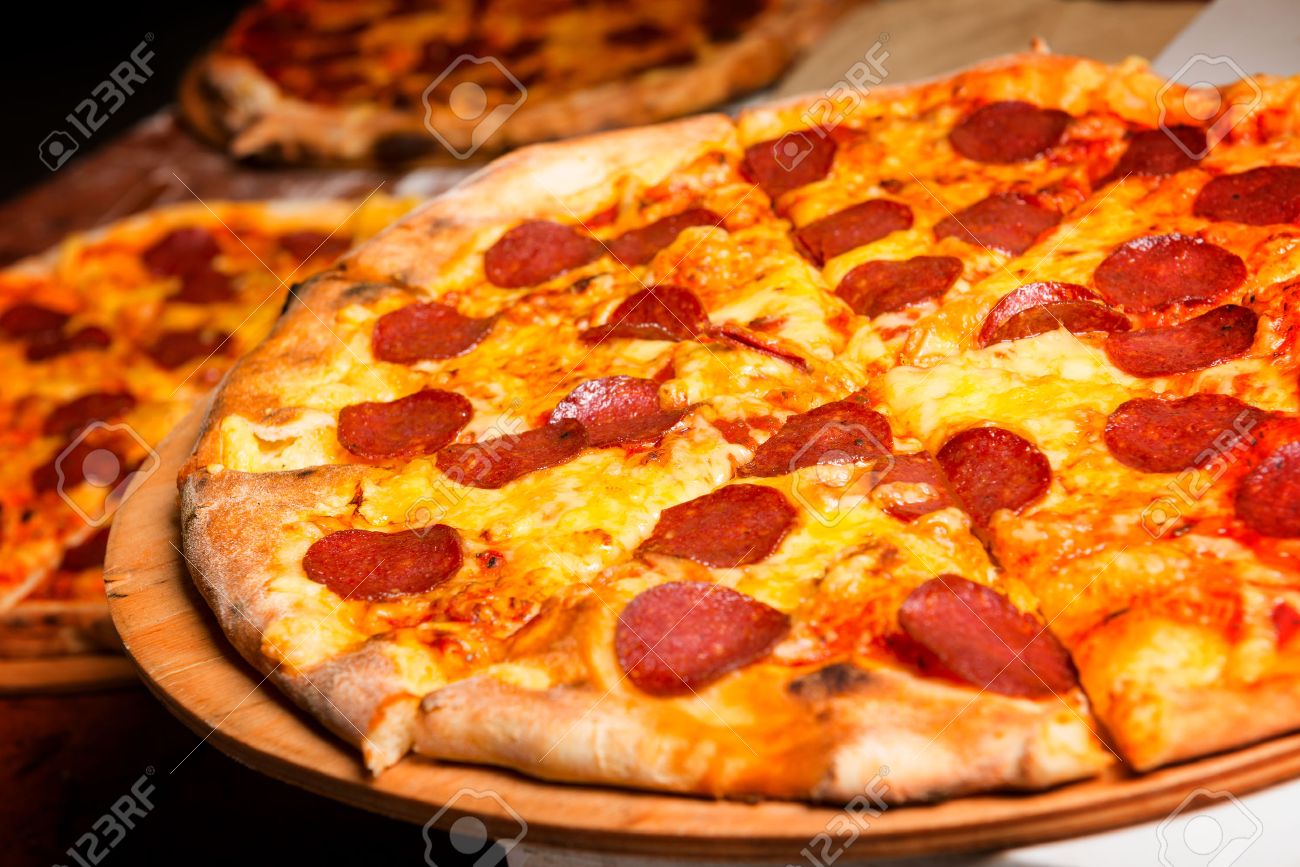 Fresh original Italian pizza on a wooden board in Italian pizzeria - 59119652 Fresh original Italian pizza on a wooden board in Italian pizzeria - 59119652