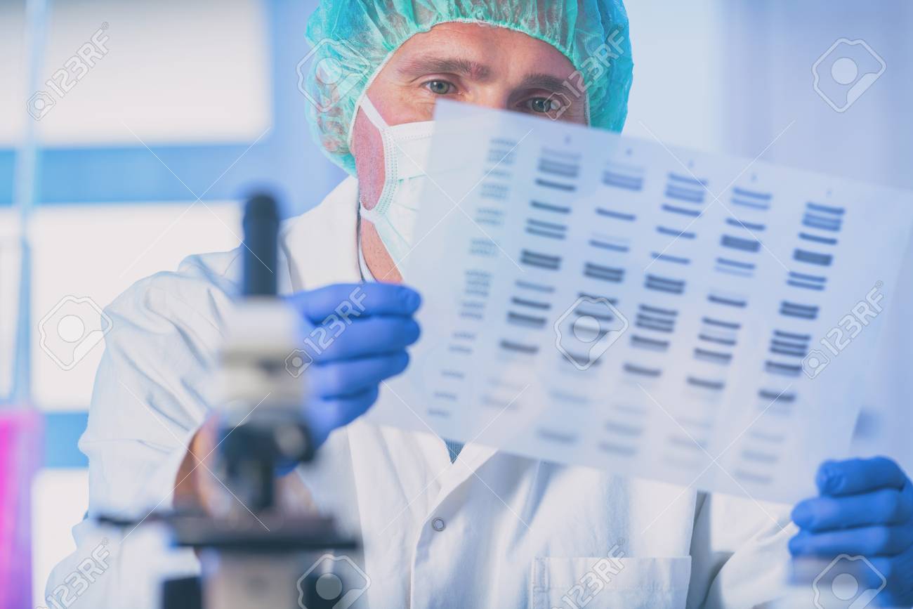 Scientist analizing DNA sequence in the modern laboratory - 121948704 Scientist analizing DNA sequence in the modern laboratory - 121948704