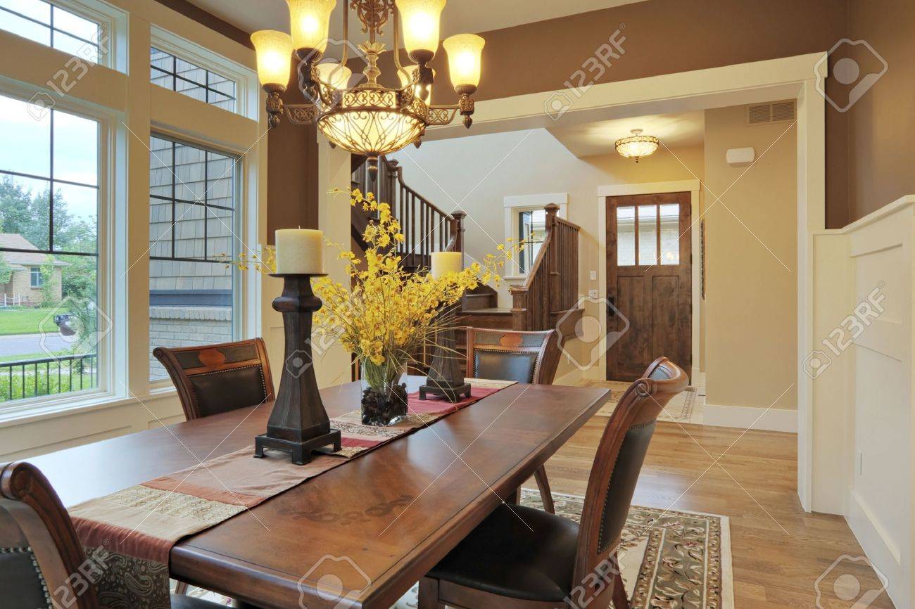 Large Dining Room With Wood Floors And Area Rug Stock Photo