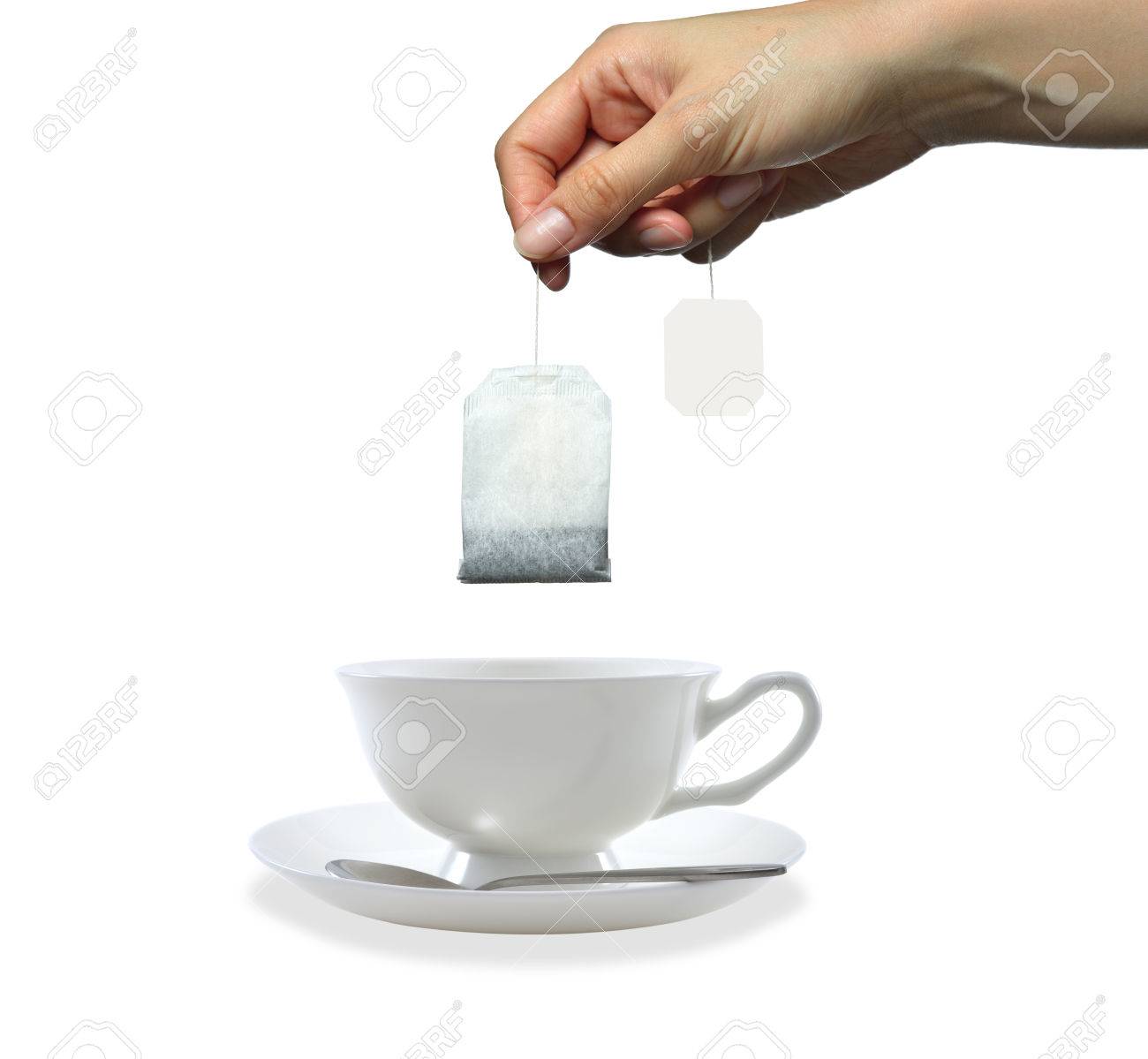 白い背景で隔離のティーバッグを持っている女性の手 の写真素材 画像素材 Image