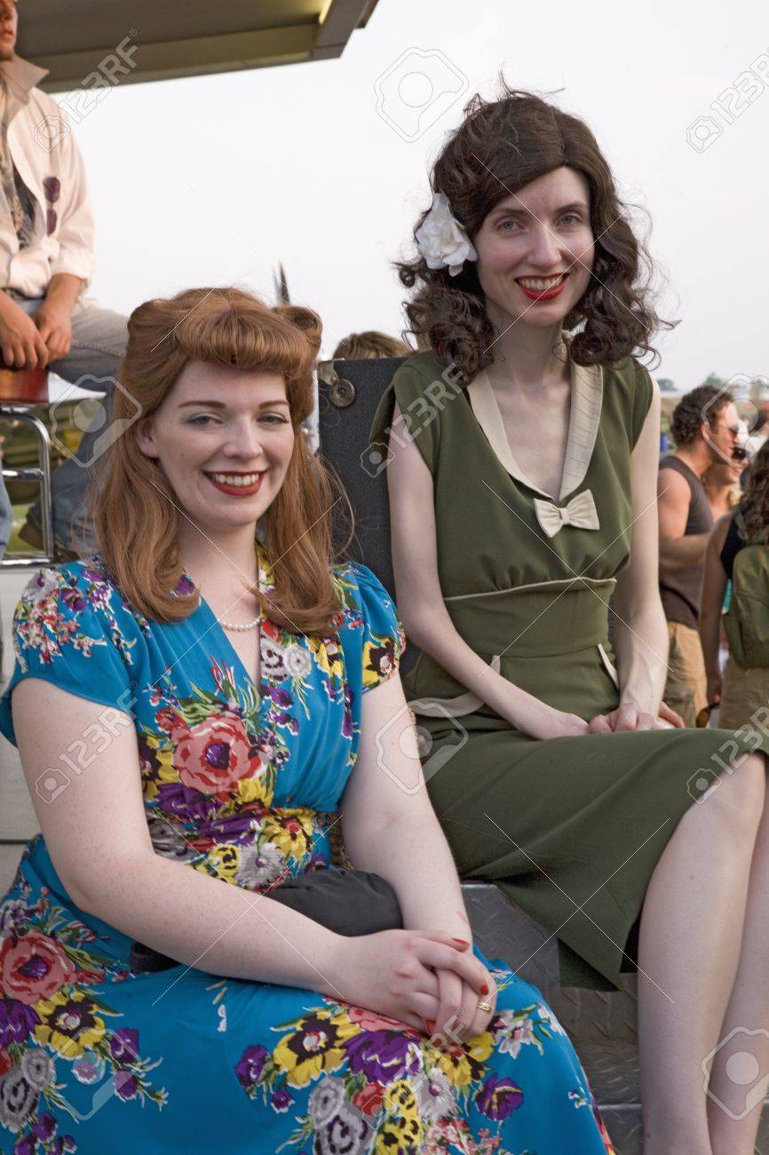 彼らは第二次世界大戦 1940 年代ビンテージ ドレス大西洋航空博物館第二次世界大戦週末に身を包んだ 2 人の女性笑顔し 読書 Pa で再現開催 08 年 6 月 18 日 の写真素材 画像素材 Image