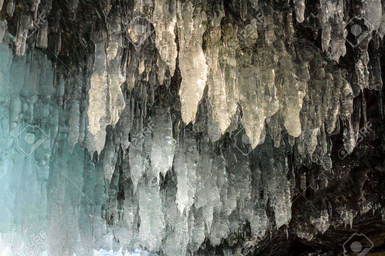 Icicles Hanging From The Ceiling Of The Stone Cave And Covering