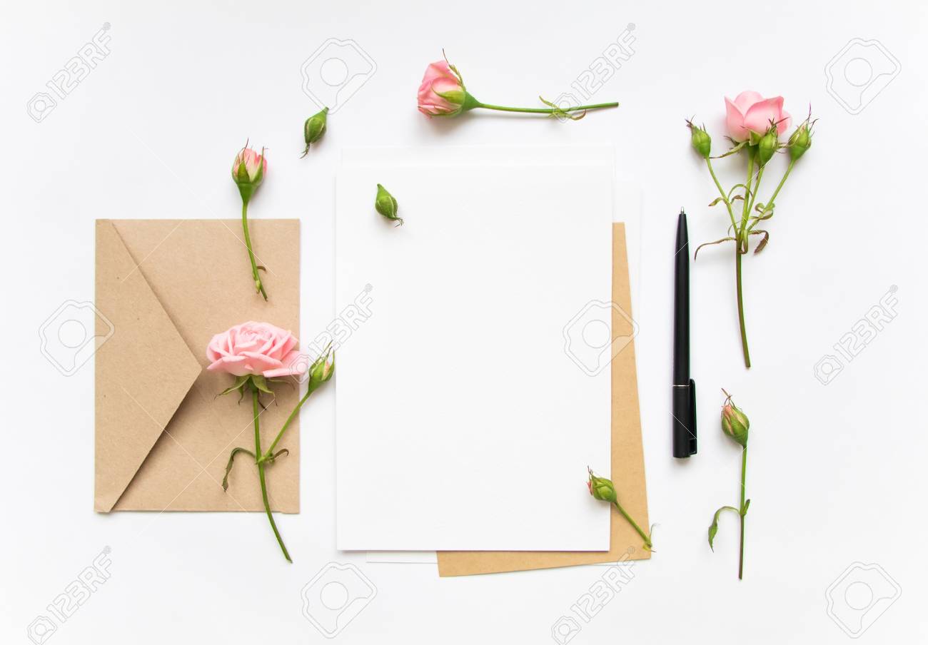 flat lay shot of letter and eco paper envelope on white background