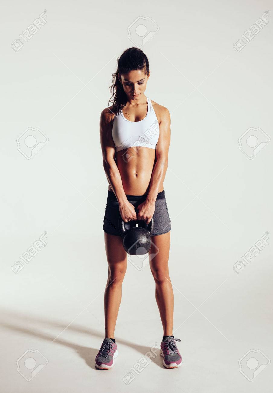 Hubsche Junge Frau Mit Der Ausubung Crossfit Mit Wasserkocher Glocke Gewicht Crossfit Frauen Arbeiten Auf Grauem Hintergrund Fokussiert Weibliche Athleten Tun Bodybuilding Ubung Auf Grauem Hintergrund Lizenzfreie Fotos Bilder Und Stock Fotografie