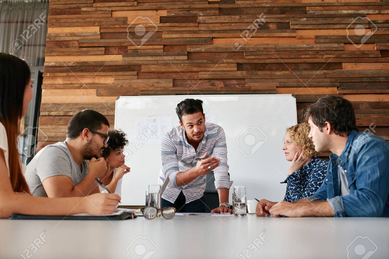 Brainstorming in a boardroom of creative office . Young creative people sitting at the table and discussing new projects. - 51078501 Brainstorming in a boardroom of creative office . Young creative people sitting at the table and discussing new projects. - 51078501