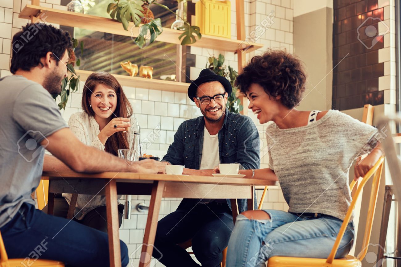 portrait of cheerful young friends having fun while talking in