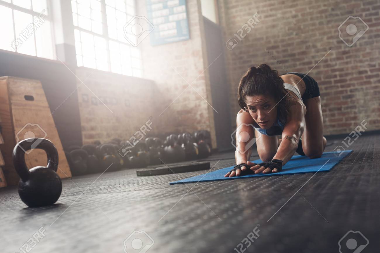 Portrait Of Determined Young Female Athlete Working Out On