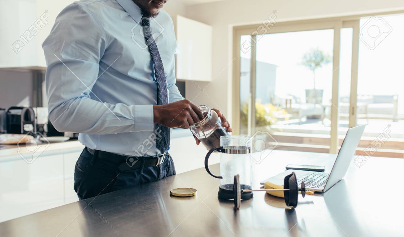 Man In Formal Clothes Making Coffee Using French Press With A