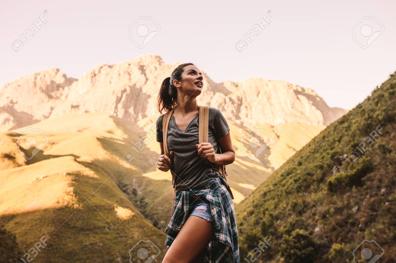 Woman Hiking In Mountains And Looking 