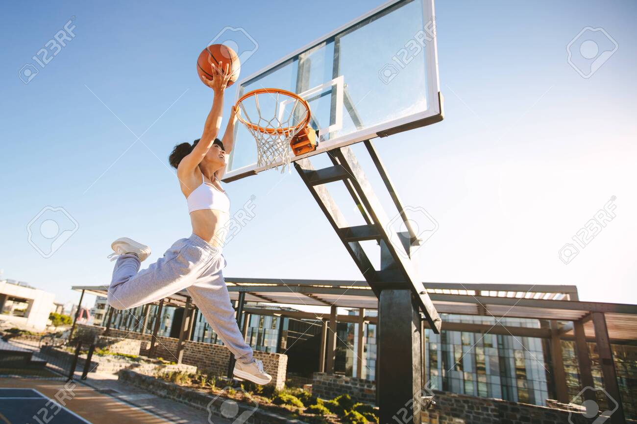 Woman Basketball Player Slam Dunking On Street Court. Female Playing  Basketball Outdoors On Summer Day. Stock Photo, Picture And Royalty Free  Image. Image 127401938.