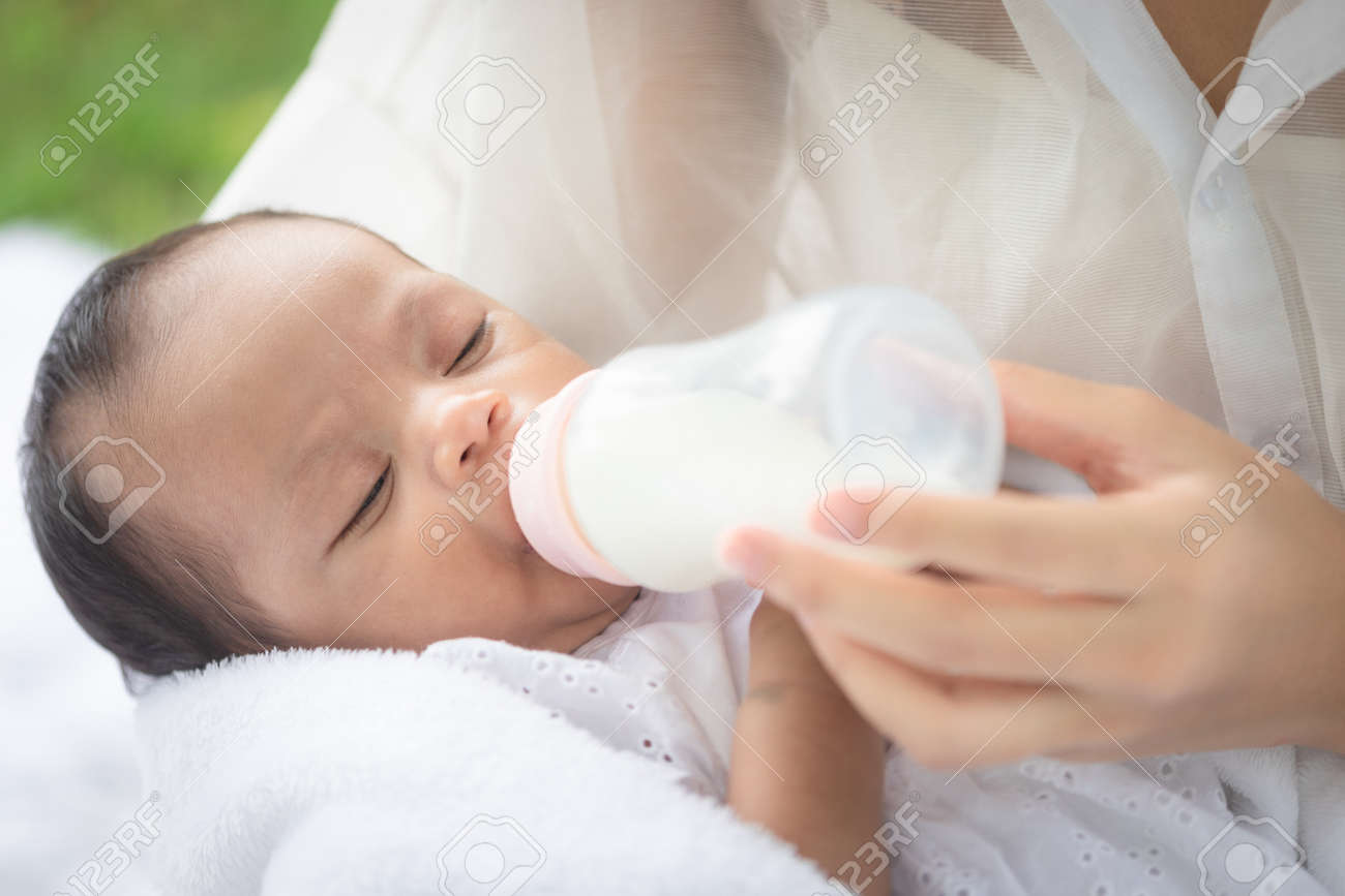 Close Up Mother S Hand Hold Bottle Milk For Feeding Her Daughter Stock Photo Picture And Royalty Free Image Image 166104377