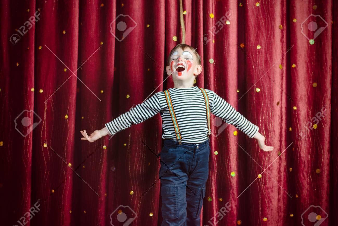 Young Boy Dressed as Clown Performing on Stage with Open Arms and Open Mouth as if Singing or Acting - 40126705 Young Boy Dressed as Clown Performing on Stage with Open Arms and Open Mouth as if Singing or Acting - 40126705