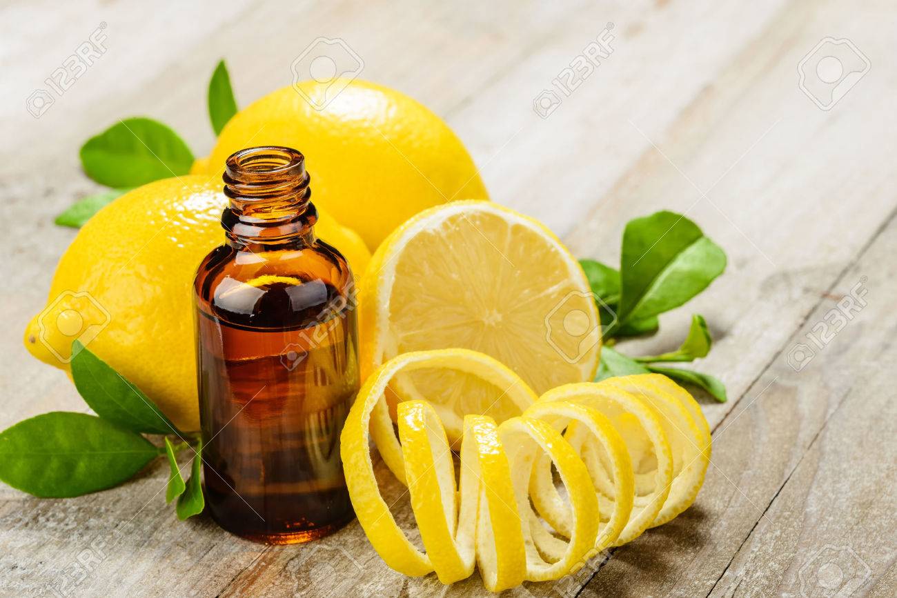 lemon essential oil and lemon fruit on the wooden board - 43695581 lemon essential oil and lemon fruit on the wooden board - 43695581