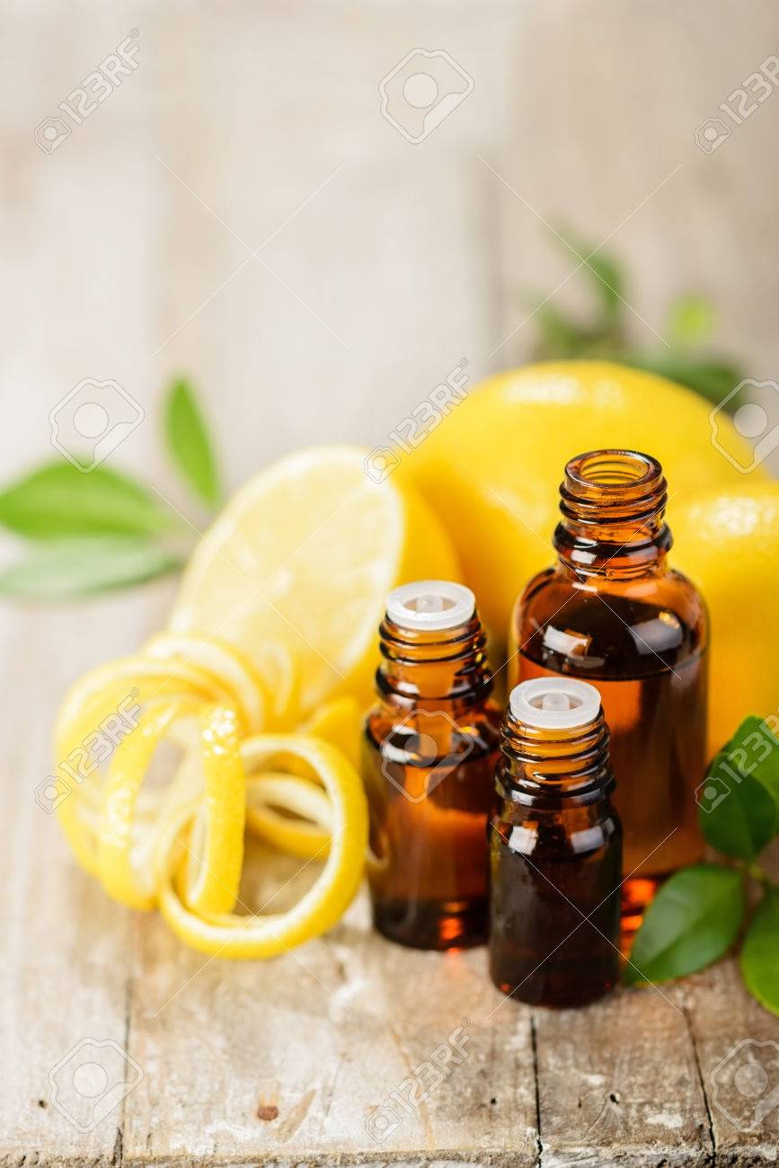 lemon essential oil and lemon fruit on the wooden board - 43695525 lemon essential oil and lemon fruit on the wooden board - 43695525