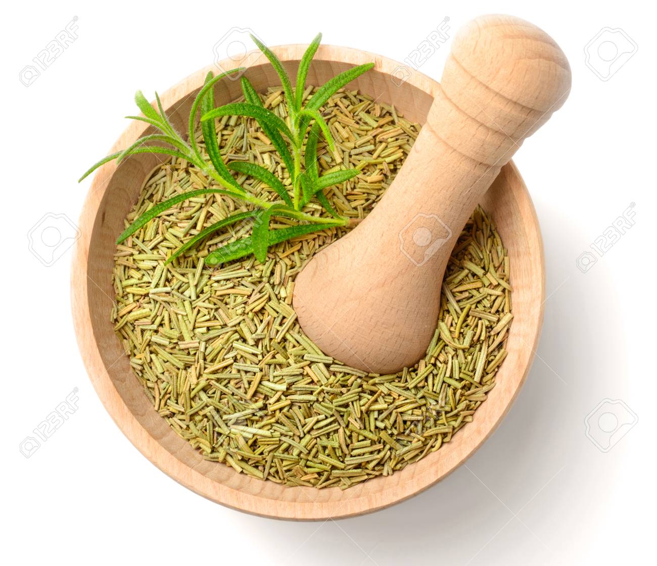 dried herbs dried rosemary leaves in the wooden mortar isolated