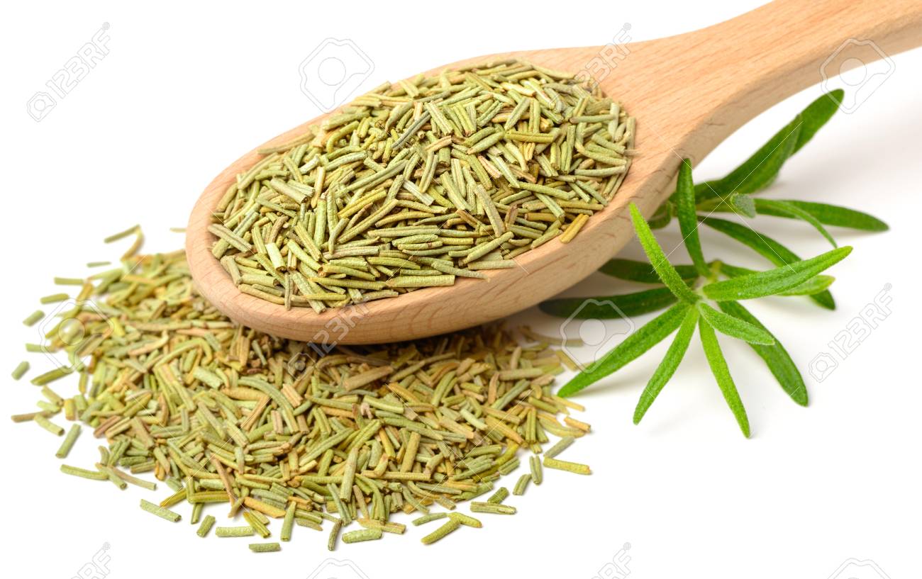 dried herbs dried rosemary leaves in the wooden spoon isolated