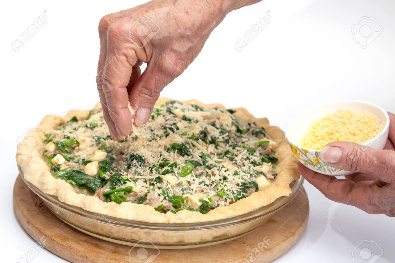 Adding Parmesan Cheese To The Spinach And Tuna Quiche Lorraine