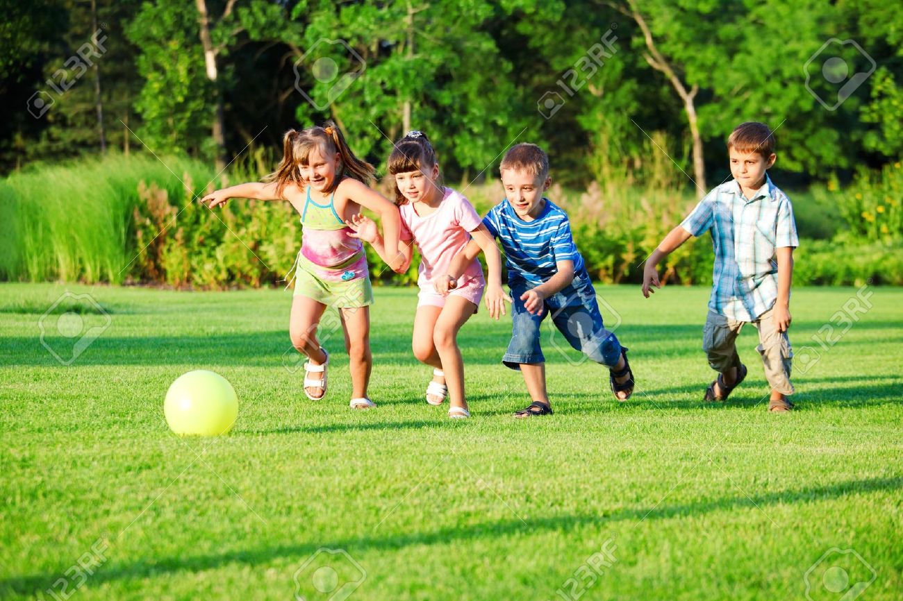 Kids Group Playing With Ball In The Backyard Stock Photo Kids Group Playing With Ball In The Backyard Stock Photo