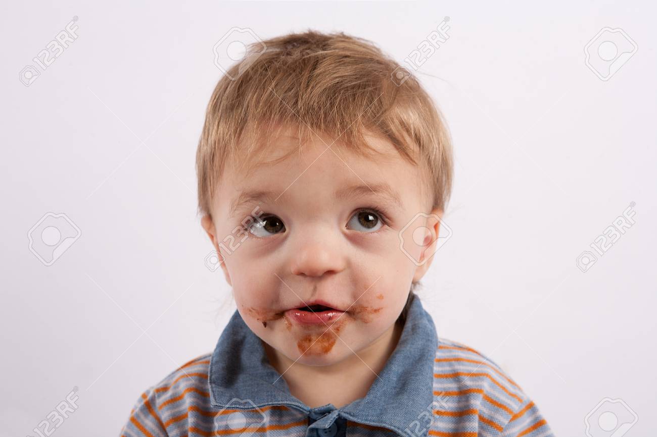 Portrait Of A Funny Baby Boy With Mouth Covered With Chocolate