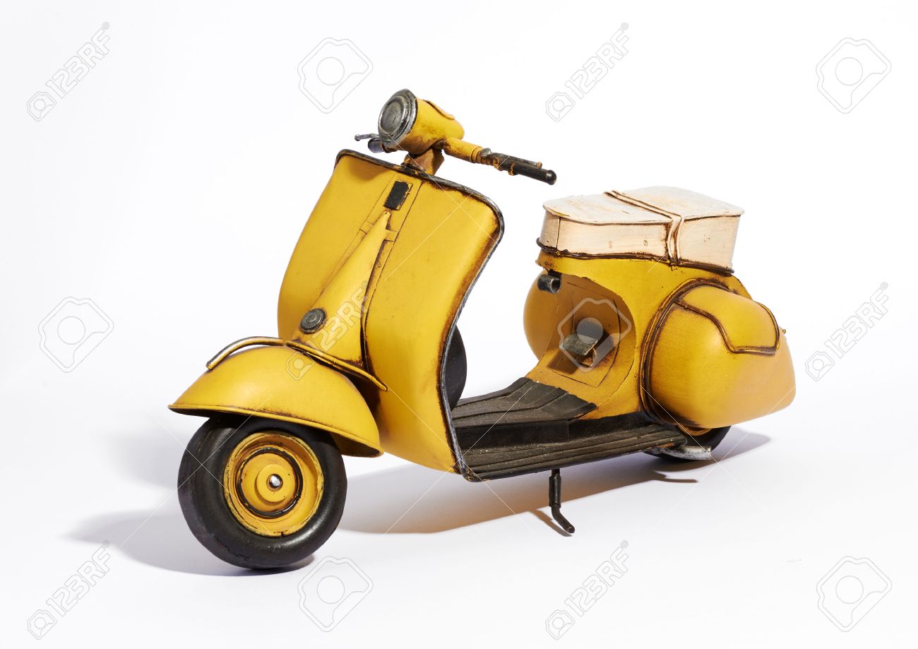 Old Classic Vintage Yellow Motor Scooter With A Wide Footboard And Saddle Style Seat Standing Upright Old Classic Vintage Yellow Motor Scooter With A Wide Footboard And Saddle Style Seat Standing Upright