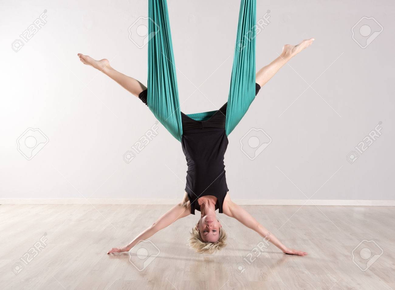 Single Upside Down Woman Doing Aerial Yoga Splits With Assistance