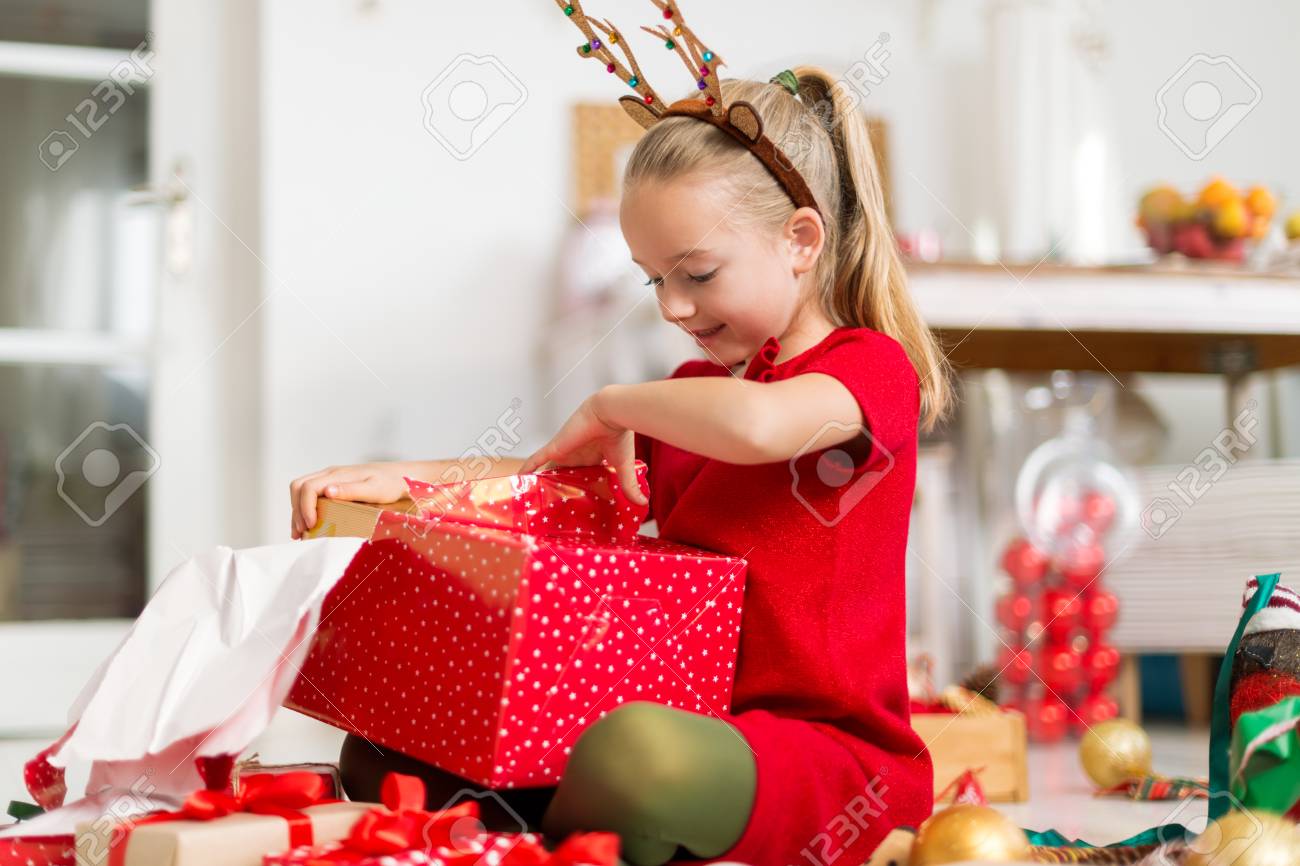 girl opening christmas presents