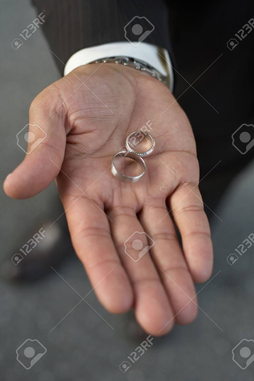 African American Hand Holding Silver Wedding Bands Dof Focus
