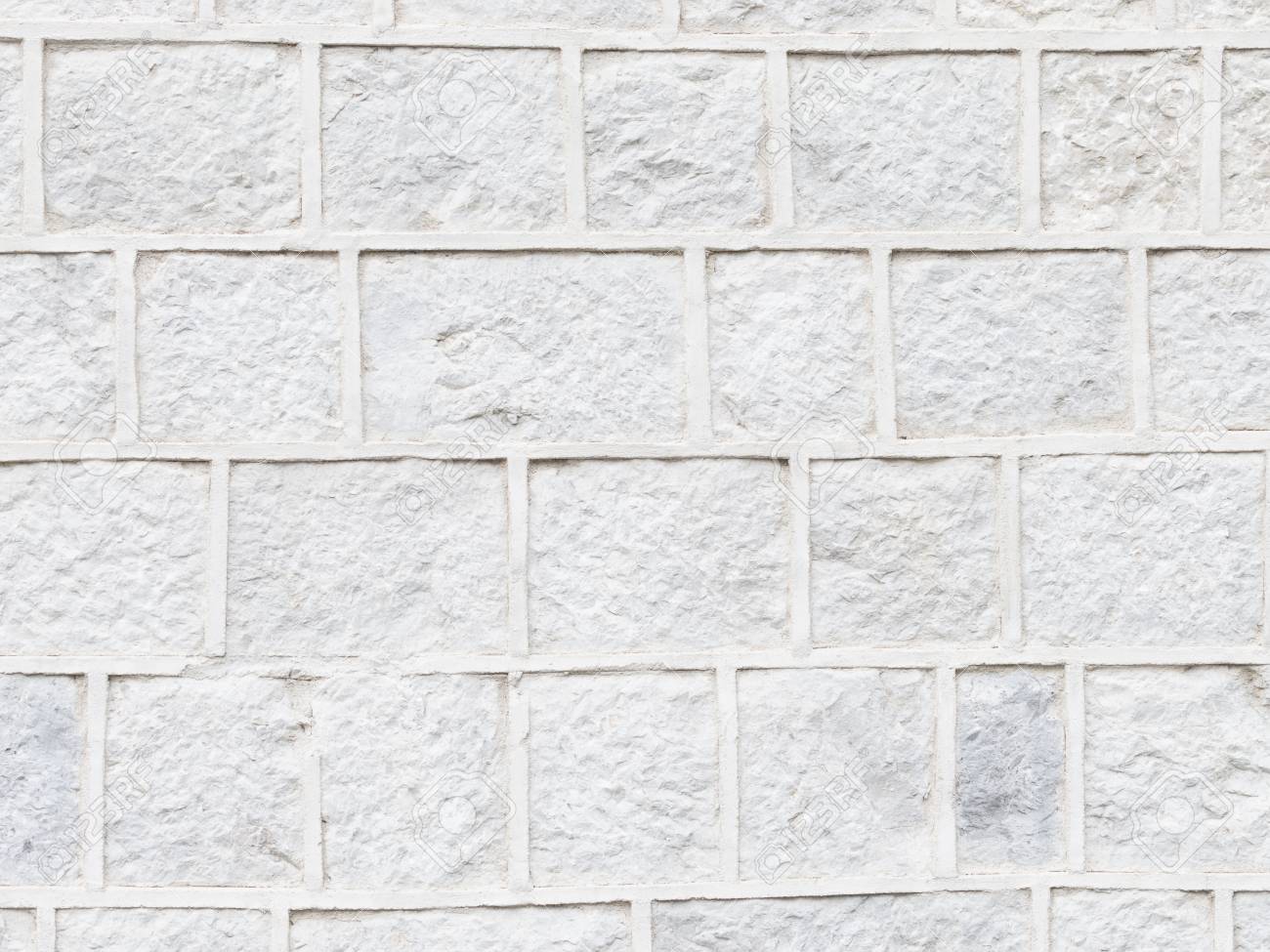 Vieille Surface Inégale Sale Dun Mur De Pierre Gris Clair Et De Coutures Convexes Posées Comme Des Briques