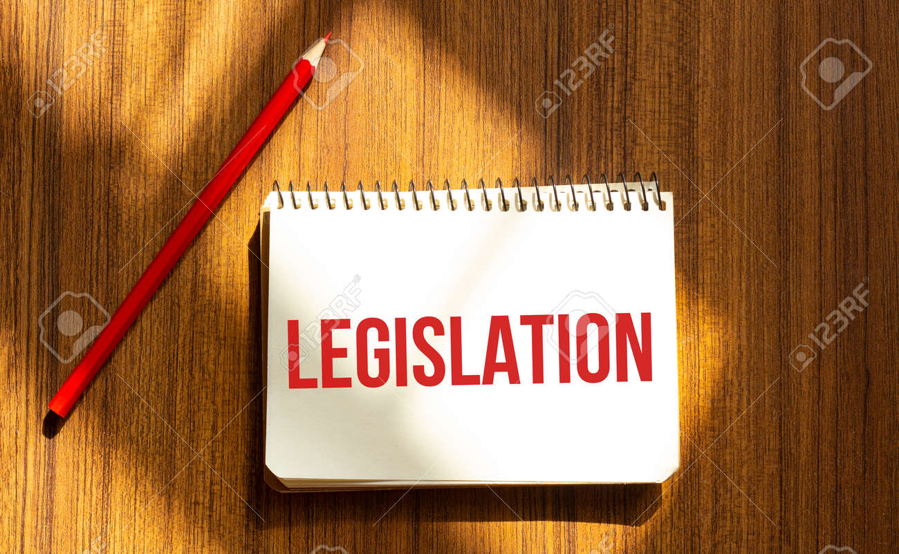 Red pen and notepad with text LEGISLATION in the white background - 157526484 Red pen and notepad with text LEGISLATION in the white background - 157526484