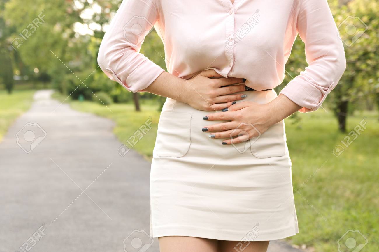 Young Woman Suffering From Abdominal Pain While Walking In Park Stock Photo Picture And Royalty Free Image Image 102503688
